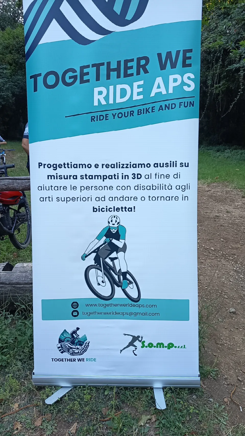 Banner di Together We Ride APS sulle protesi stampate in 3D per andare in bicicletta