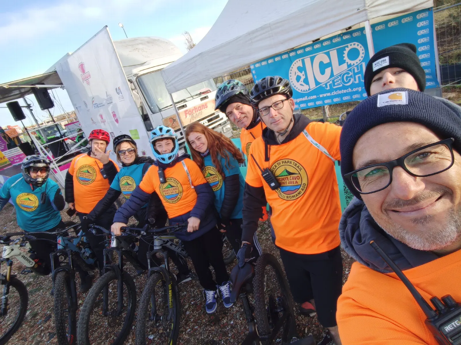 Soci dell'ASD con biciclette e caschi allo stand Ciclo durante la Corsa di Chiara